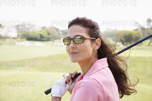 Woman playing golf on course