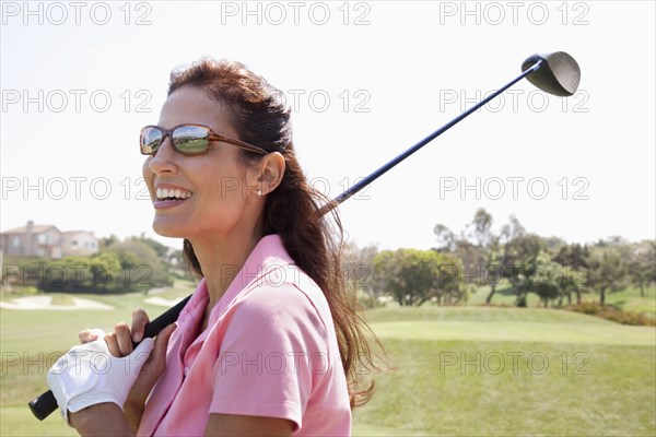 Woman playing golf on course