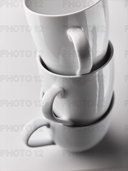 Close up of stacked white mugs