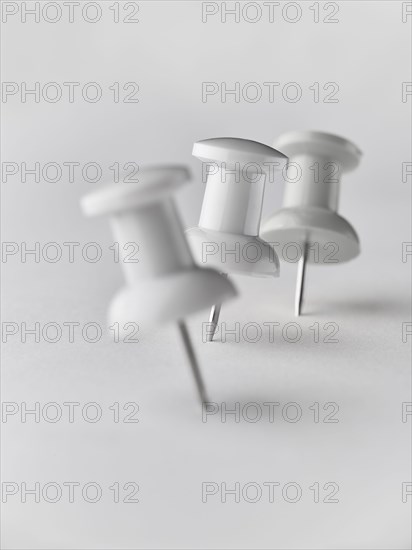 Close up of three white pushpins