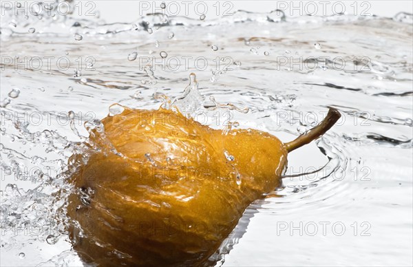 Close up of pear splashing in water