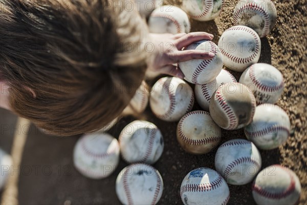 Caucasian boy choosing baseball on field