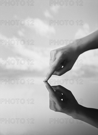 Close up of hand touching still water