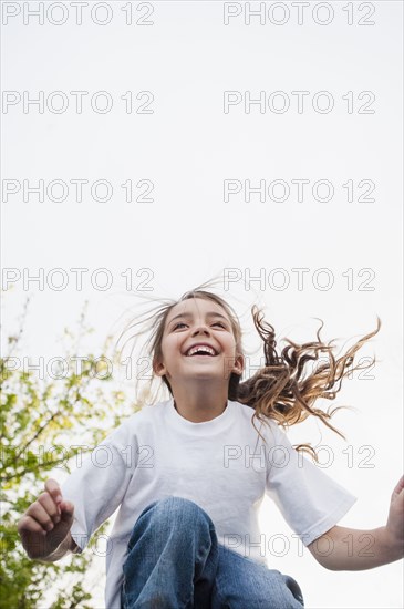 Mixed Race girl smiling and jumping