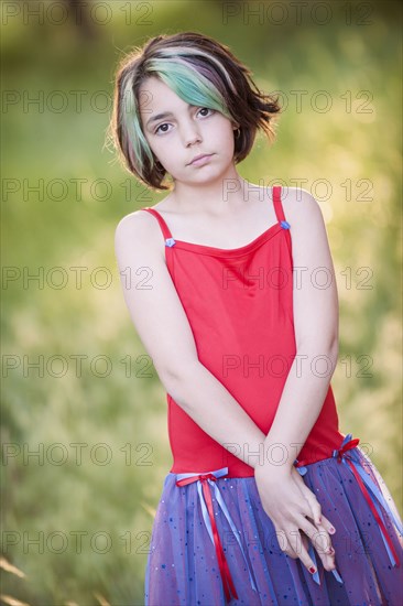 Serious Mixed Race girl with multicolor hair