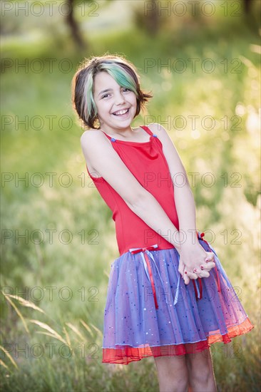 Smiling Mixed Race girl with multicolor hair