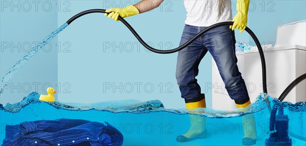 Man pumping water in flooding laundry room