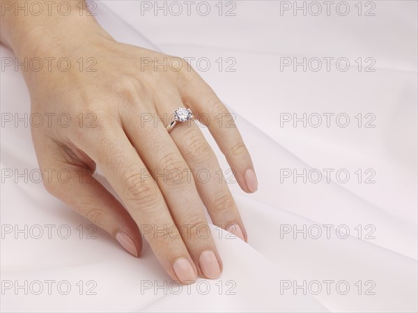 Hand of woman wearing engagement ring