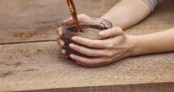 Hands of woman holding coffee cup