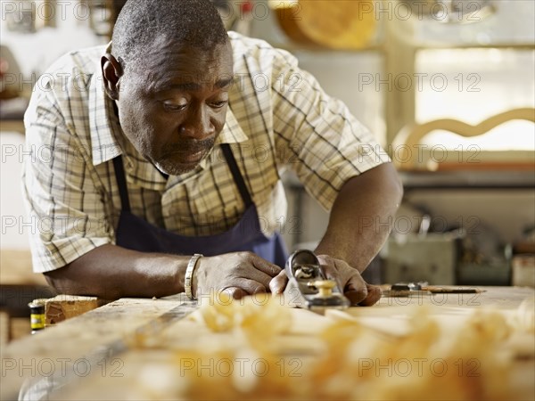 Black craftsman working in workshop