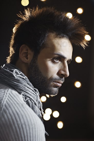 Serious Caucasian man with beard at night