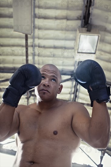 Hispanic boxer training in gym