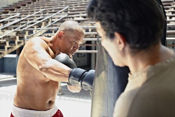 Hispanic boxer training in gym