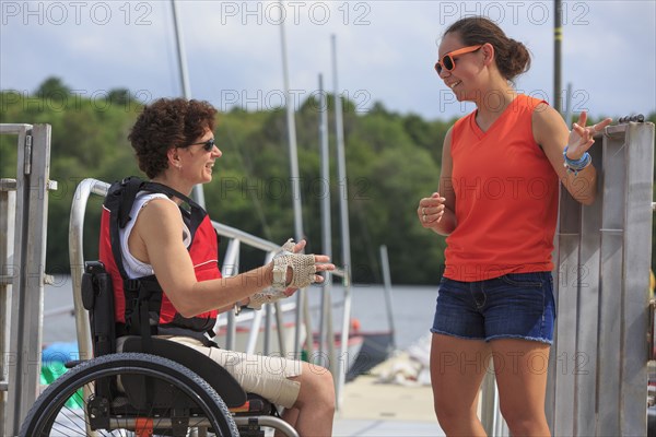 Caucasian women talking at marina