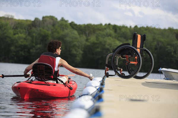 Caucasian paraplegic woman rowing kayak