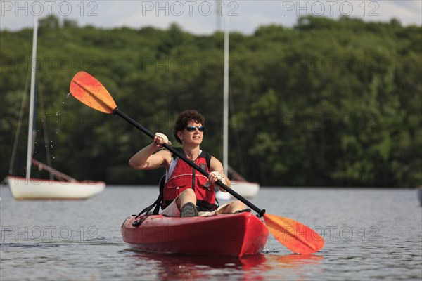 Caucasian woman rowing kayak