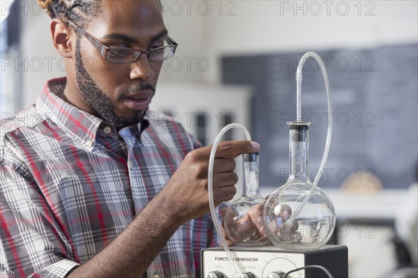 Student performing experiment in science classroom