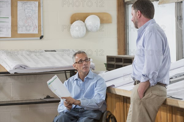 Caucasian architects talking in office