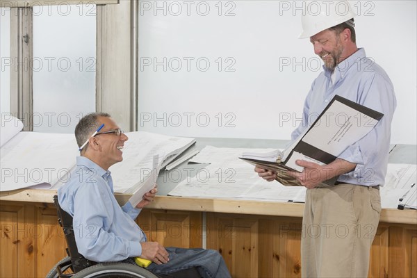 Caucasian architects talking in office