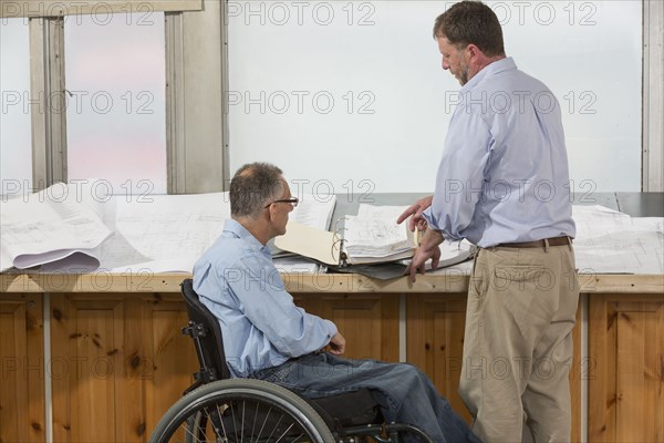 Caucasian architects talking in office