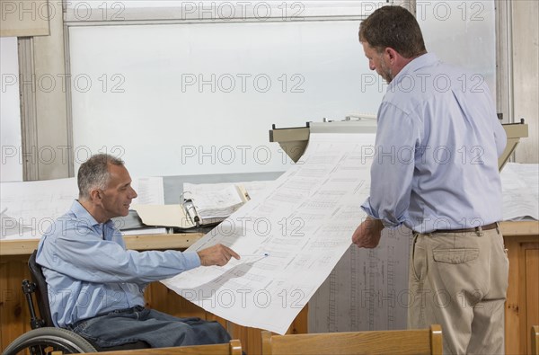 Caucasian architects talking in office