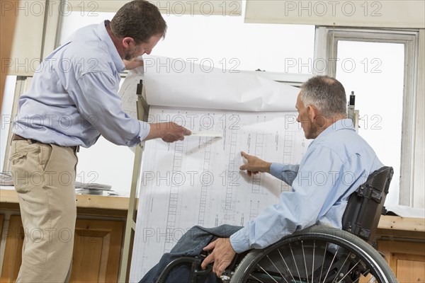 Caucasian architects talking in office