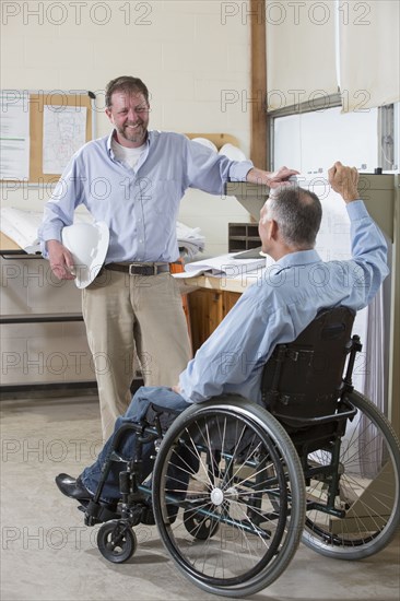 Caucasian architects talking in office