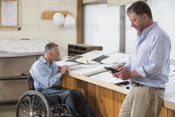 Caucasian architects talking in office