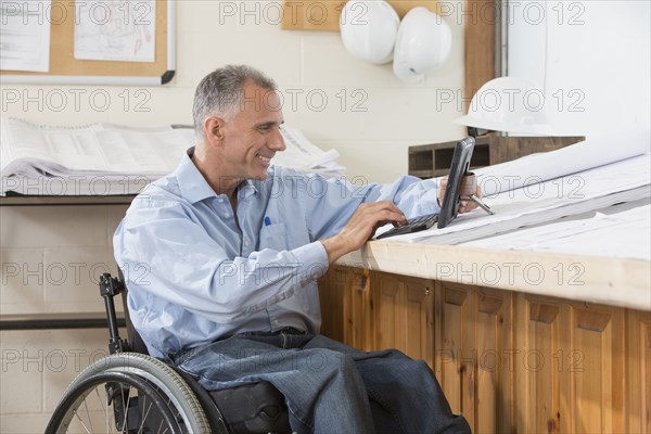 Caucasian architect using digital tablet in office