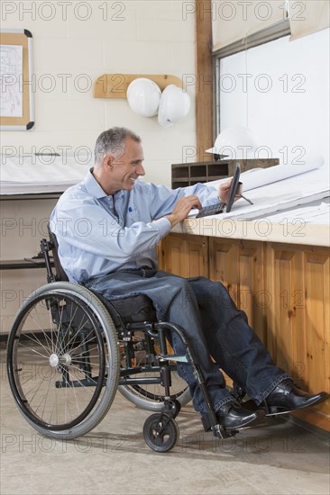 Caucasian architect using digital tablet in office