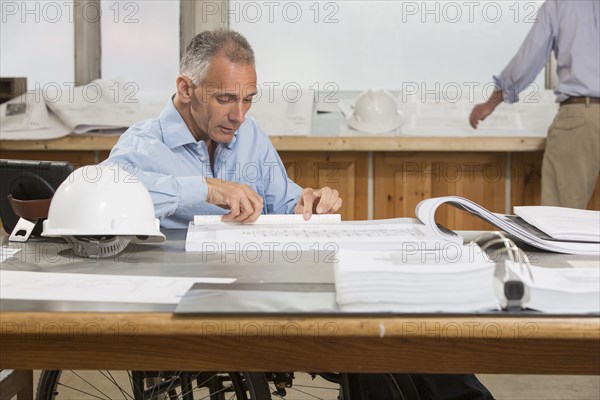 Caucasian architects working in office
