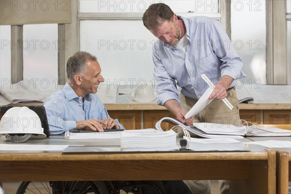 Caucasian architects working in office