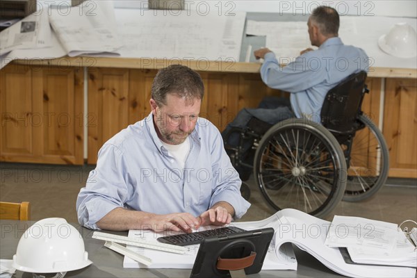 Caucasian architects working in office