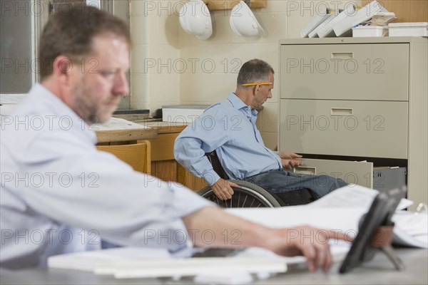 Caucasian architects working in office