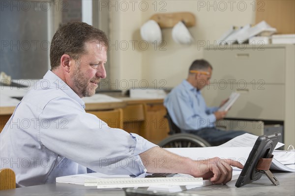 Caucasian architects working in office