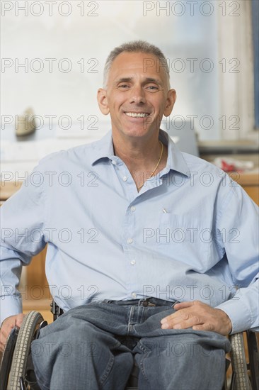 Caucasian businessman smiling in wheelchair