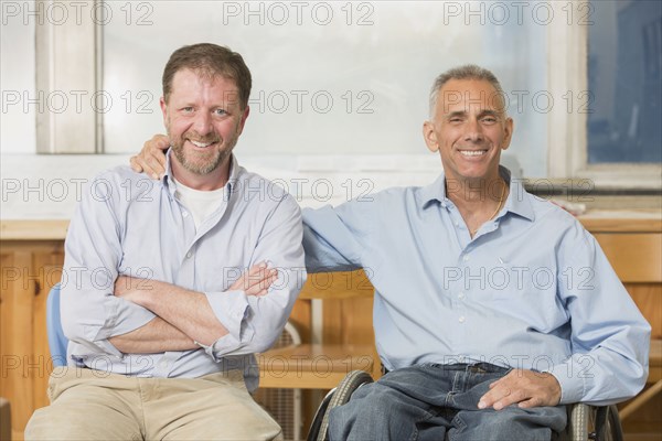 Caucasian businessmen smiling in office