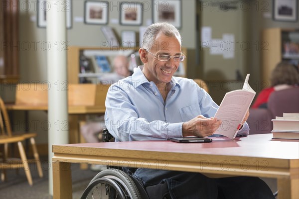 Caucasian man reading in library