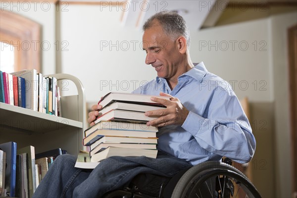 Caucasian man choosing book in library