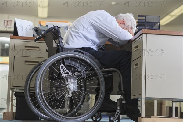 Caucasian businessman resting on office desk