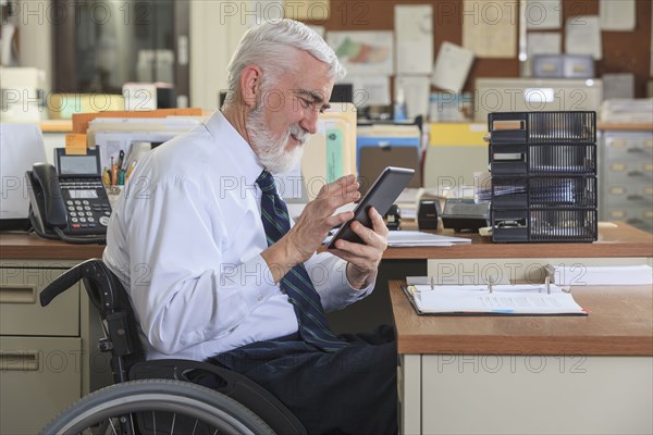 Caucasian businessman using digital tablet in office