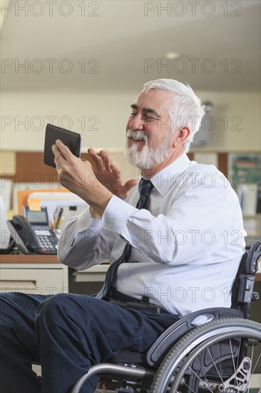 Caucasian businessman using digital tablet in office