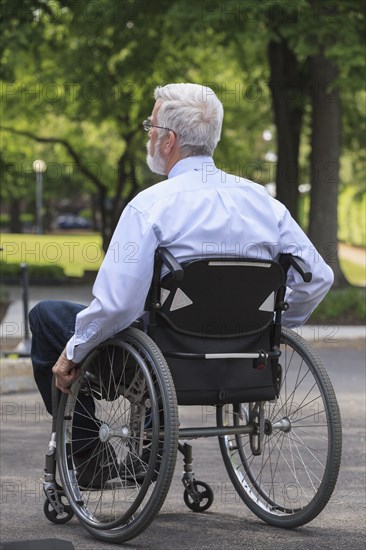 Caucasian businessman in wheelchair outdoors