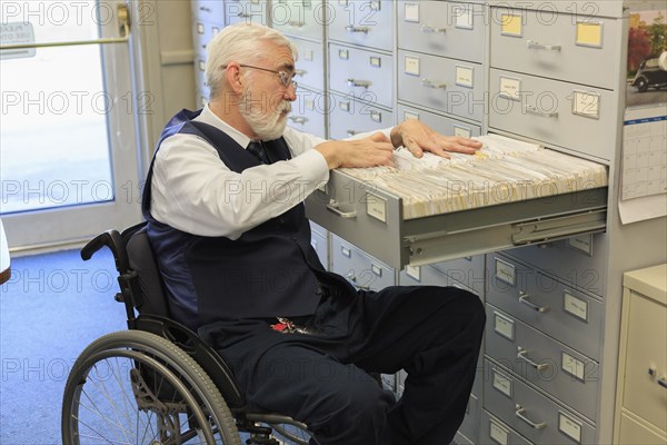 Caucasian businessman filing papers in office