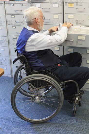 Caucasian businessman filing papers in office