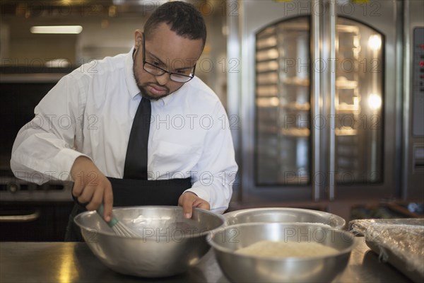 Mixed race chef with down syndrome cooking in restaurant