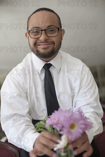 Mixed race man arranging flowers