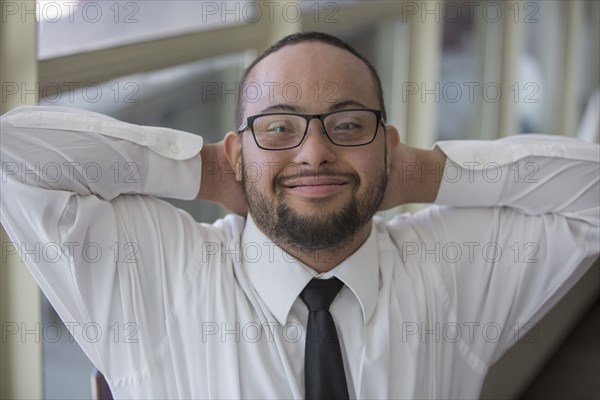 Mixed race server with down syndrome smiling in restaurant