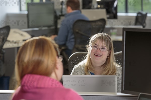 Caucasian businesswomen talking in office