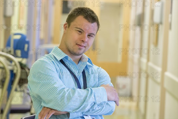 Caucasian man with Down Syndrome working in hospital